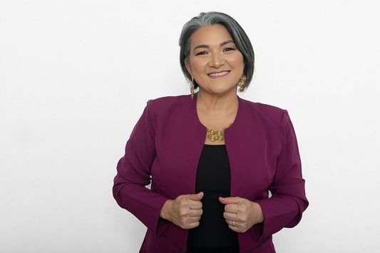 Confident gray-haired woman in a purple blazer