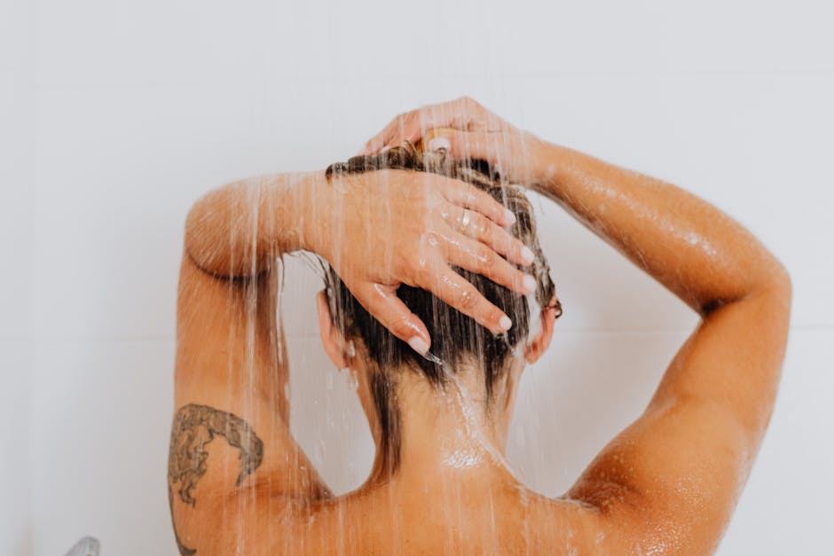 Silver-haired woman in bathroom — how to stop grey hair from turning yellow
