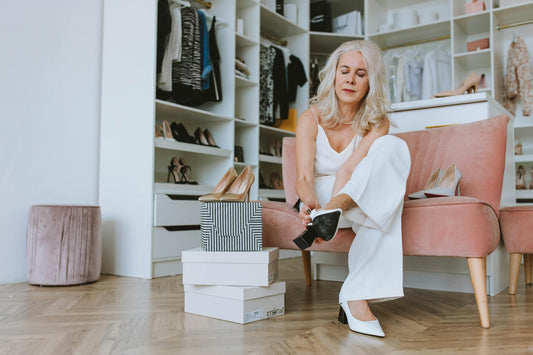 Senior woman trying on shoes in a walk-in closet