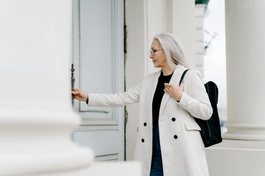 Stylish senior woman in white coat — midlife reinvention