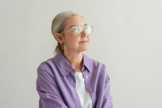 Senior woman with grey hair in a casual purple top